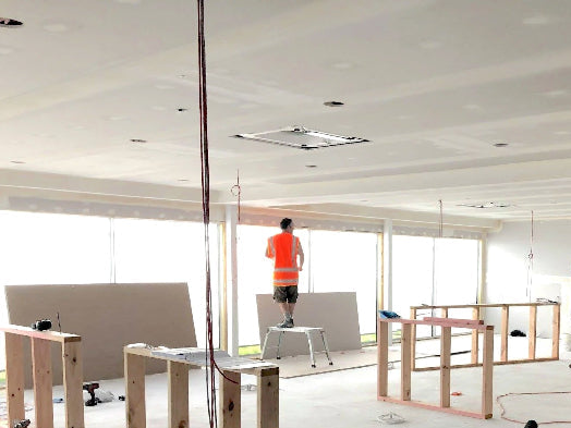 Construction site with workers and unfinished interior space