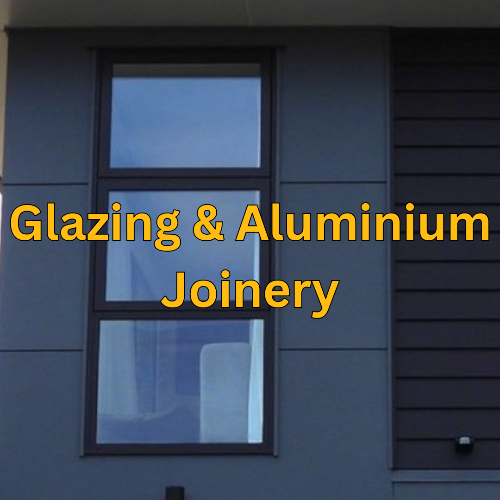 Window with text 'Glazing & Aluminium Joinery' on a blue building facade