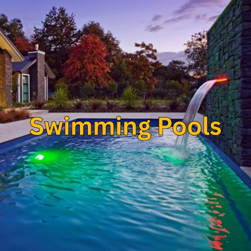 Swimming pool with water feature and text 'Swimming Pools' at dusk.