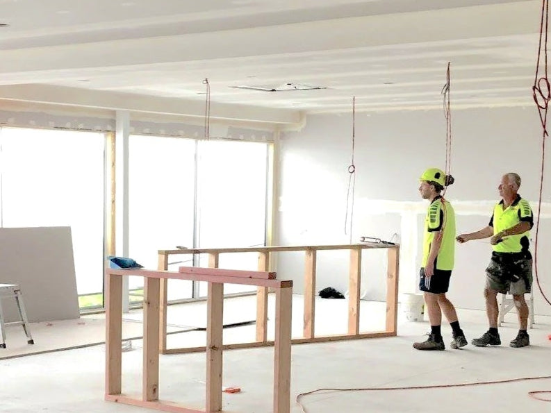 Construction site with workers and unfinished interior space