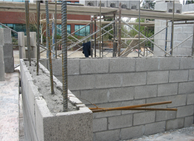 Construction site with concrete block wall and rebar